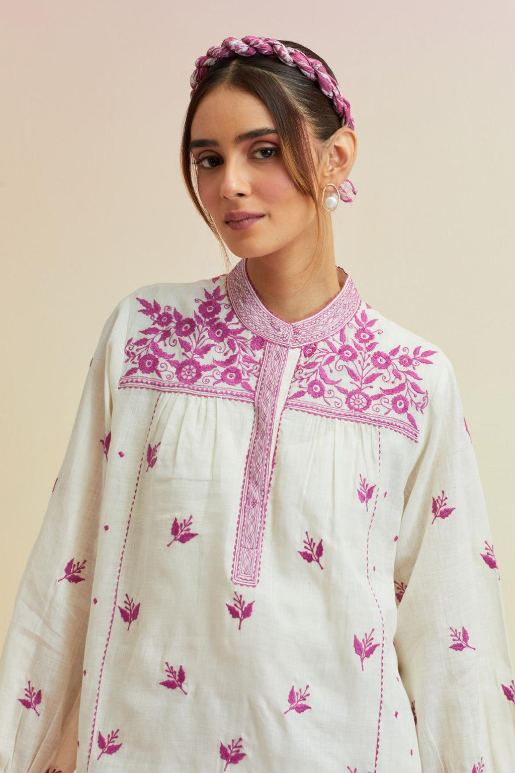 Off white cotton straight short top with all-over orchid pink thread embroidery.