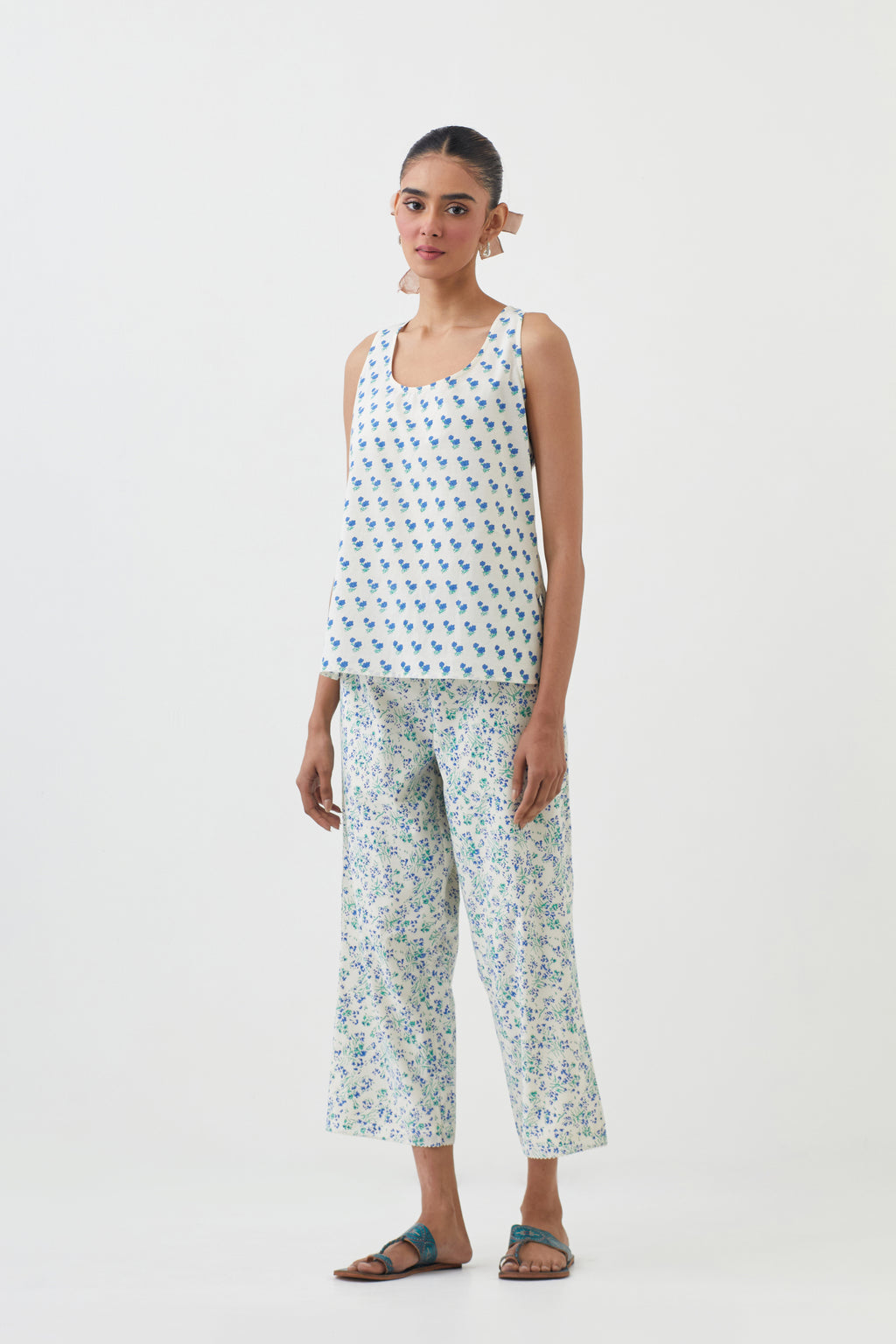 Blue hand block printed short top with hand block printed cotton slip inside, paired with off white hand block printed Cotton ankle length straight pants with all-over blue colored flower.