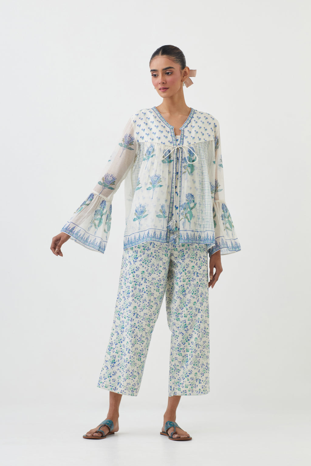 Blue hand block printed short top with hand block printed cotton slip inside, paired with off white hand block printed Cotton ankle length straight pants with all-over blue colored flower.