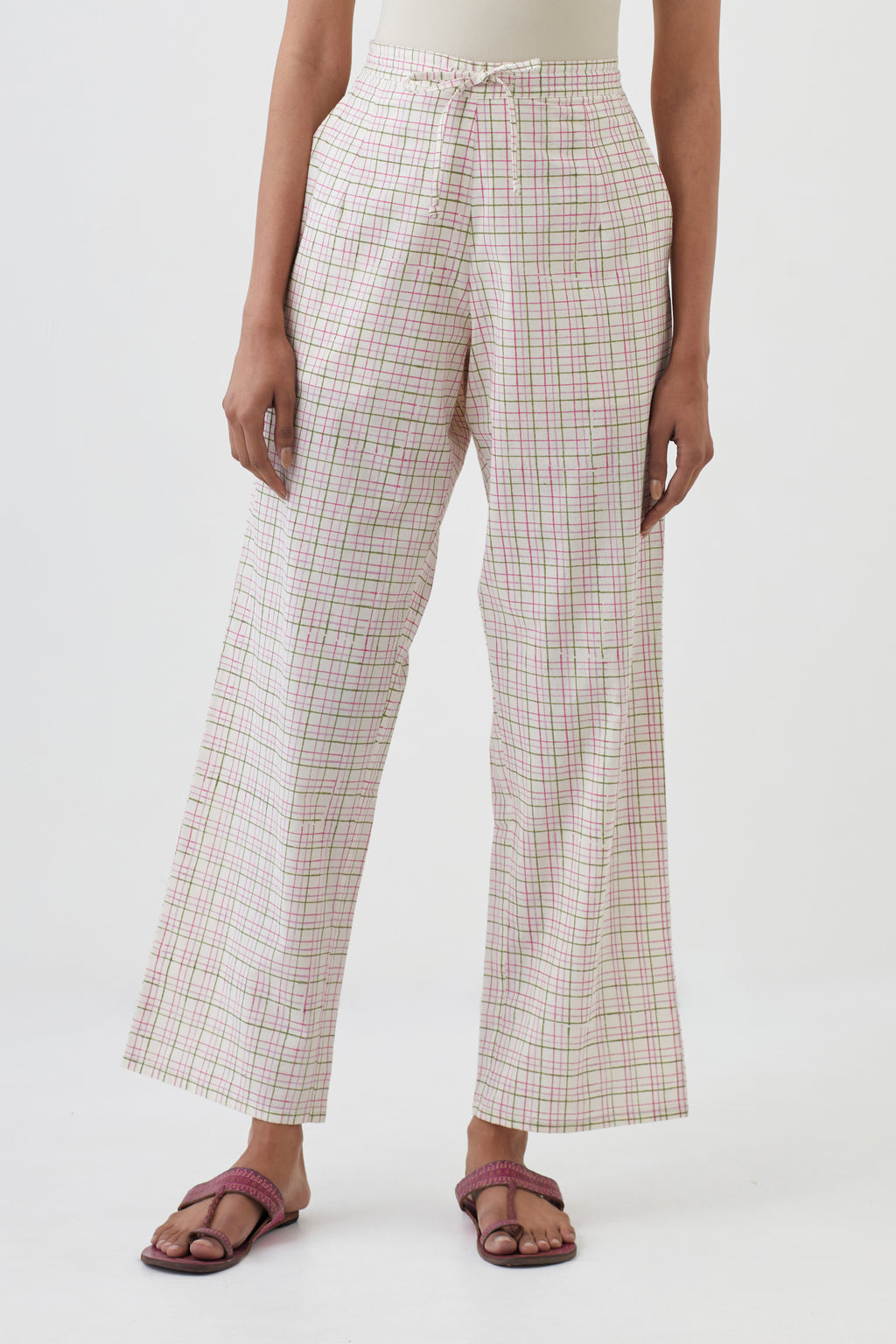 Off white cotton straight pants with all-over check hand block print.