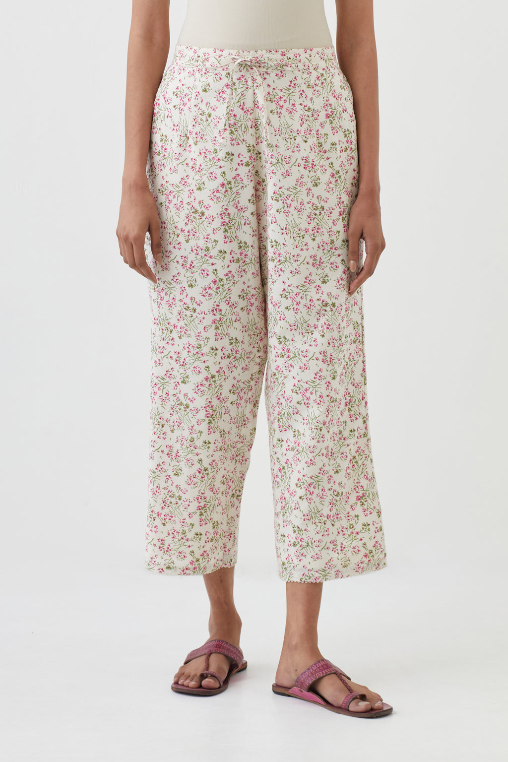 Off white cotton ankle length pants with all-over hand block print.