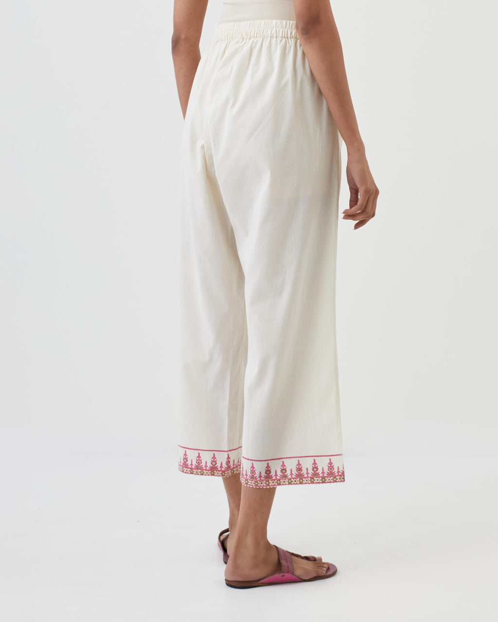 Off white cotton ankle length pants with hand block print detailing at bottom hem.