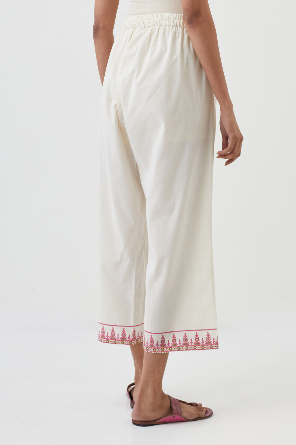 Off white cotton ankle length pants with hand block print detailing at bottom hem.