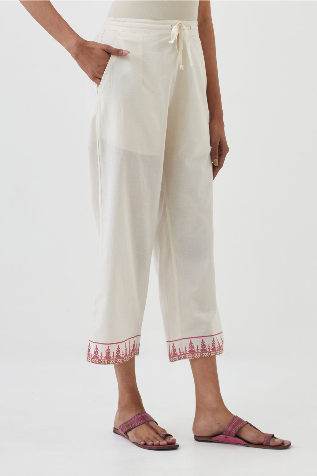 Off white cotton ankle length pants with hand block print detailing at bottom hem.