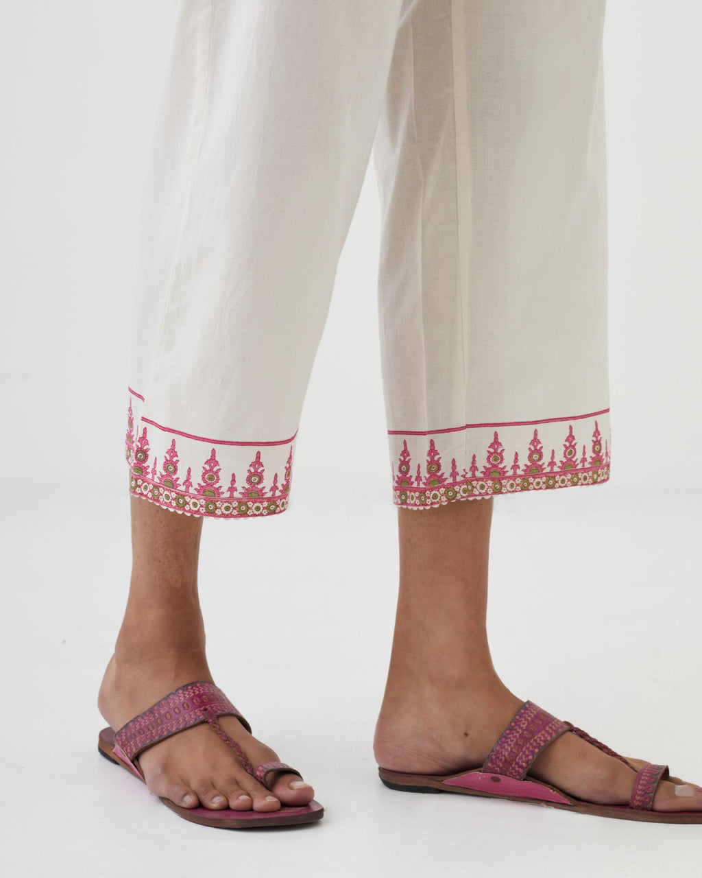 Off white cotton ankle length pants with hand block print detailing at bottom hem.