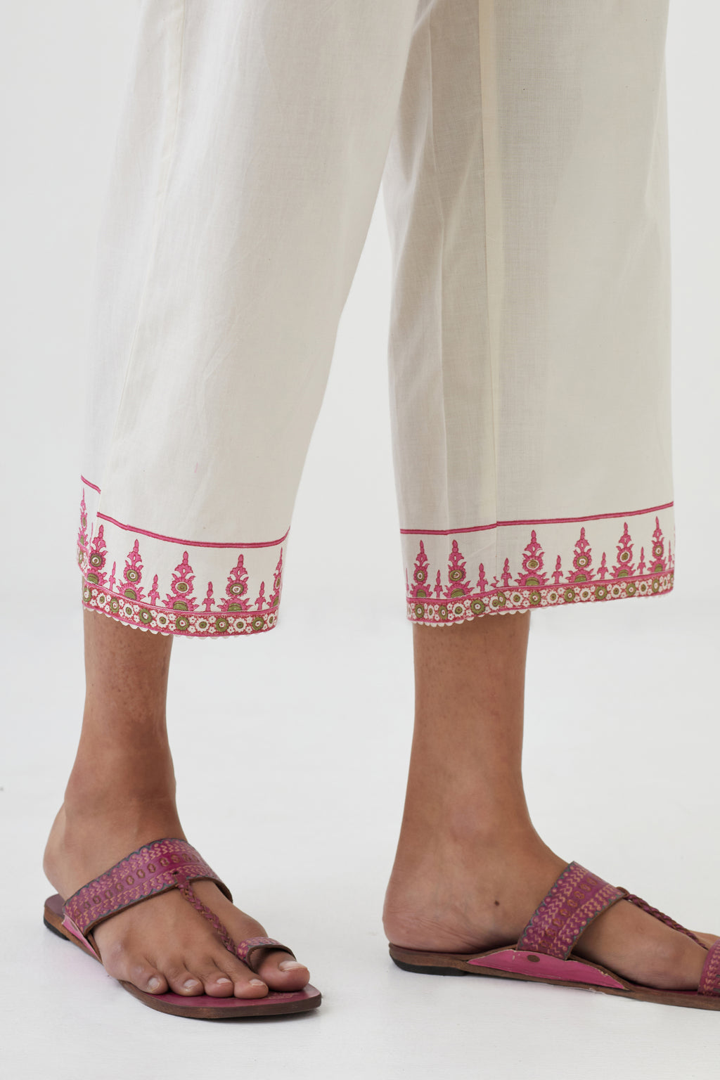 Off white cotton ankle length pants with hand block print detailing at bottom hem.