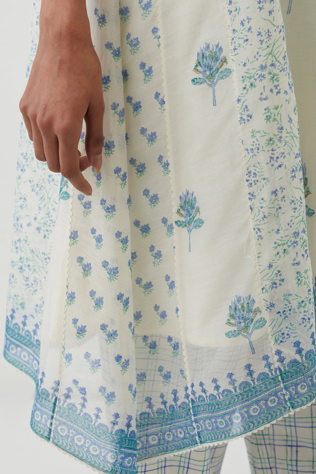 Off white hand block printed cotton chanderi short kalidar kurta set with all-over blue colored flower.