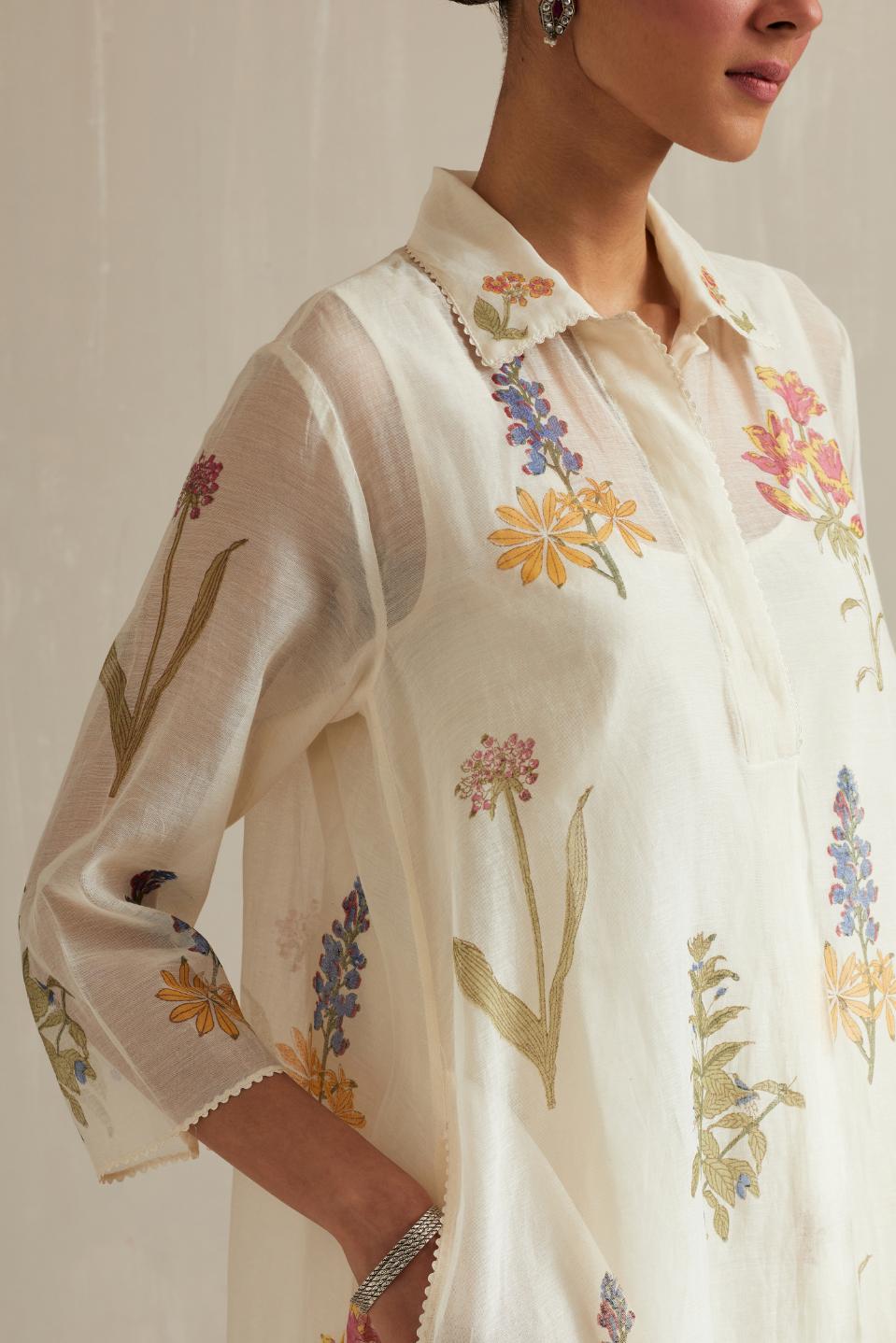 Off white hand block printed A-line short kurta set with all-over multi colored flower.