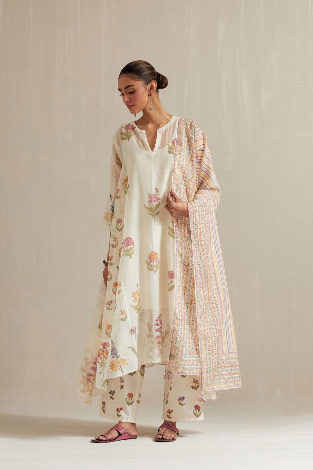 Off white hand block printed easy fit, asymmetric hem, paneled kurta set with all-over multi colored flower.