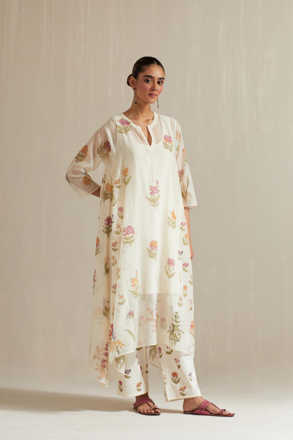 Off white hand block printed easy fit, asymmetric hem, paneled kurta set with all-over multi colored flower.