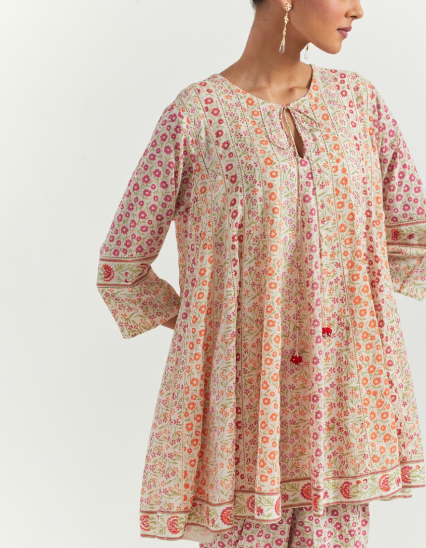 Multi colored cotton short paneled kurta with all-over small ditsy flower hand block print, paired with cotton dhoti with all over small flower hand block print.