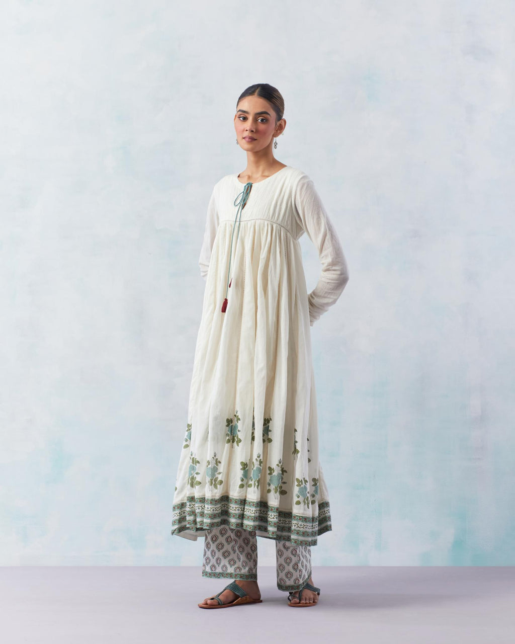 Off white hand block printed multi-paneled kurta dress set with churidaar sleeves and quilted yoke.