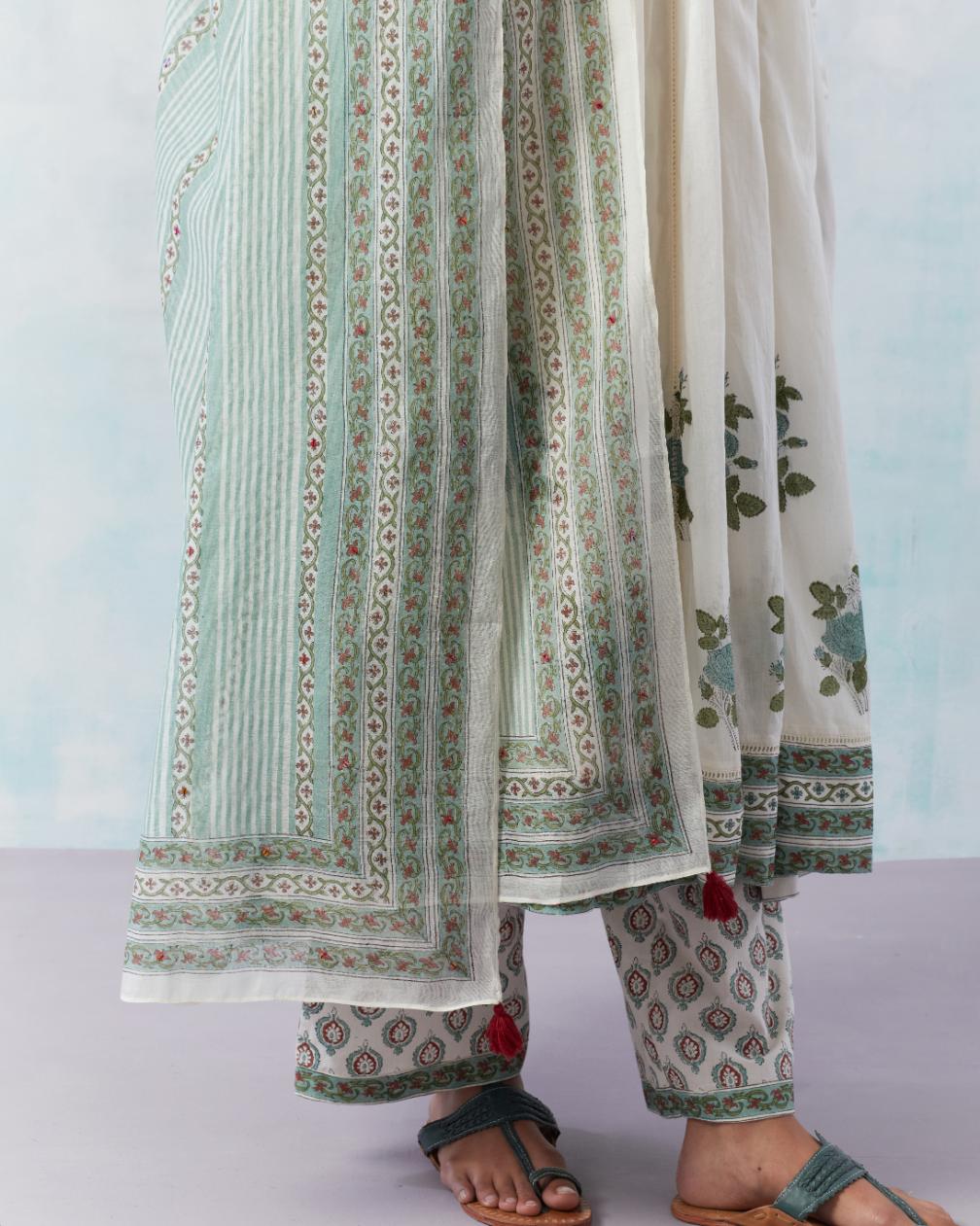 Off white hand block printed multi-paneled kurta dress set with churidaar sleeves and quilted yoke.