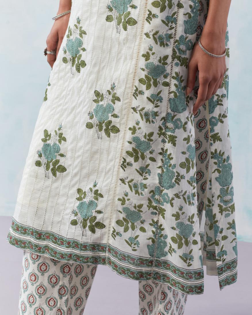 Off white cotton hand block printed straight kurta set with all-over teal green flowers and side panels attached with ladder lace.