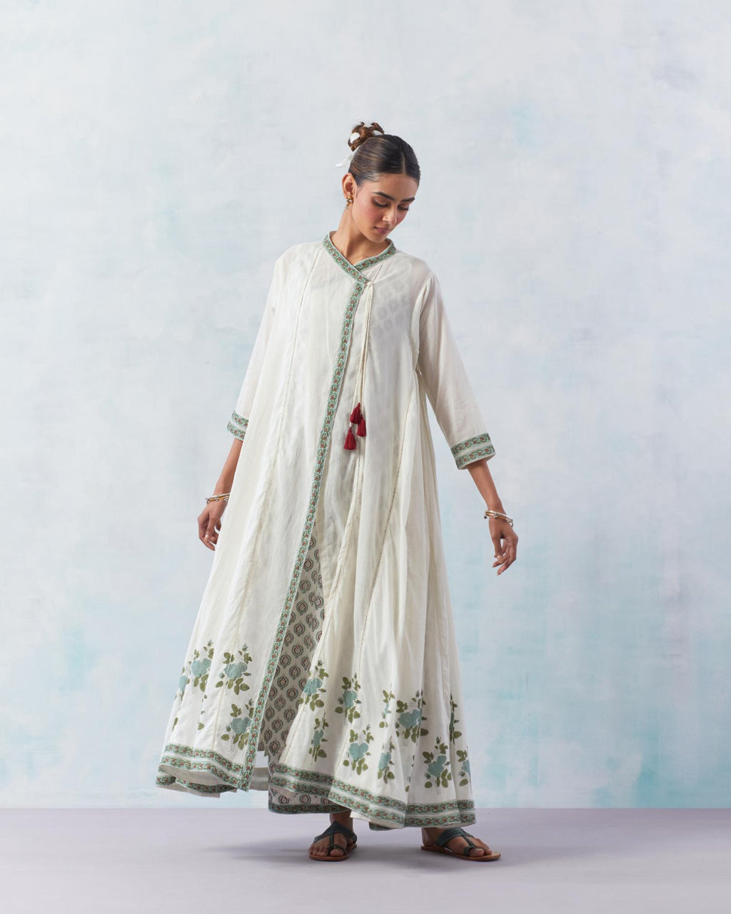 Off white hand block printed angrakha kurta set with printed slip inside and panels are attached with ladder lace.