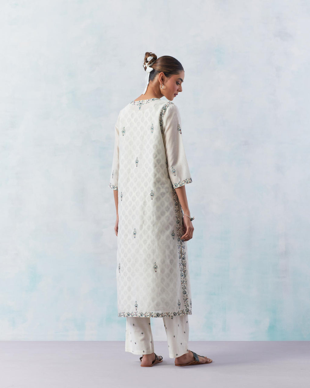 Off white silk chanderi straight kurta, highlighted with contrast silk thread embroidery, highlighted with red sequins.