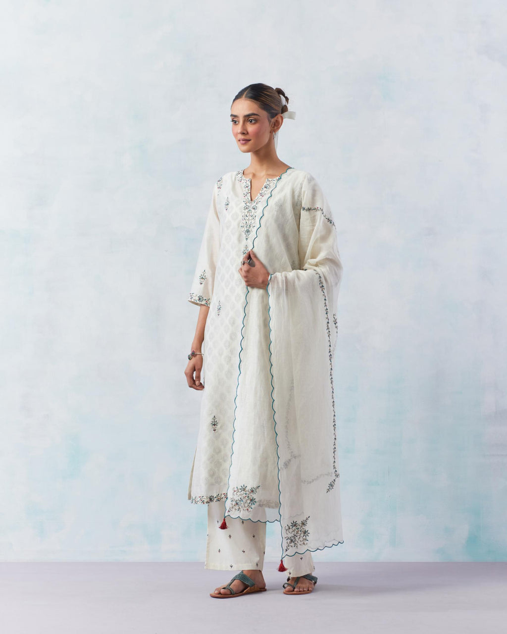 Off white silk chanderi straight kurta, highlighted with contrast silk thread embroidery, highlighted with red sequins.
