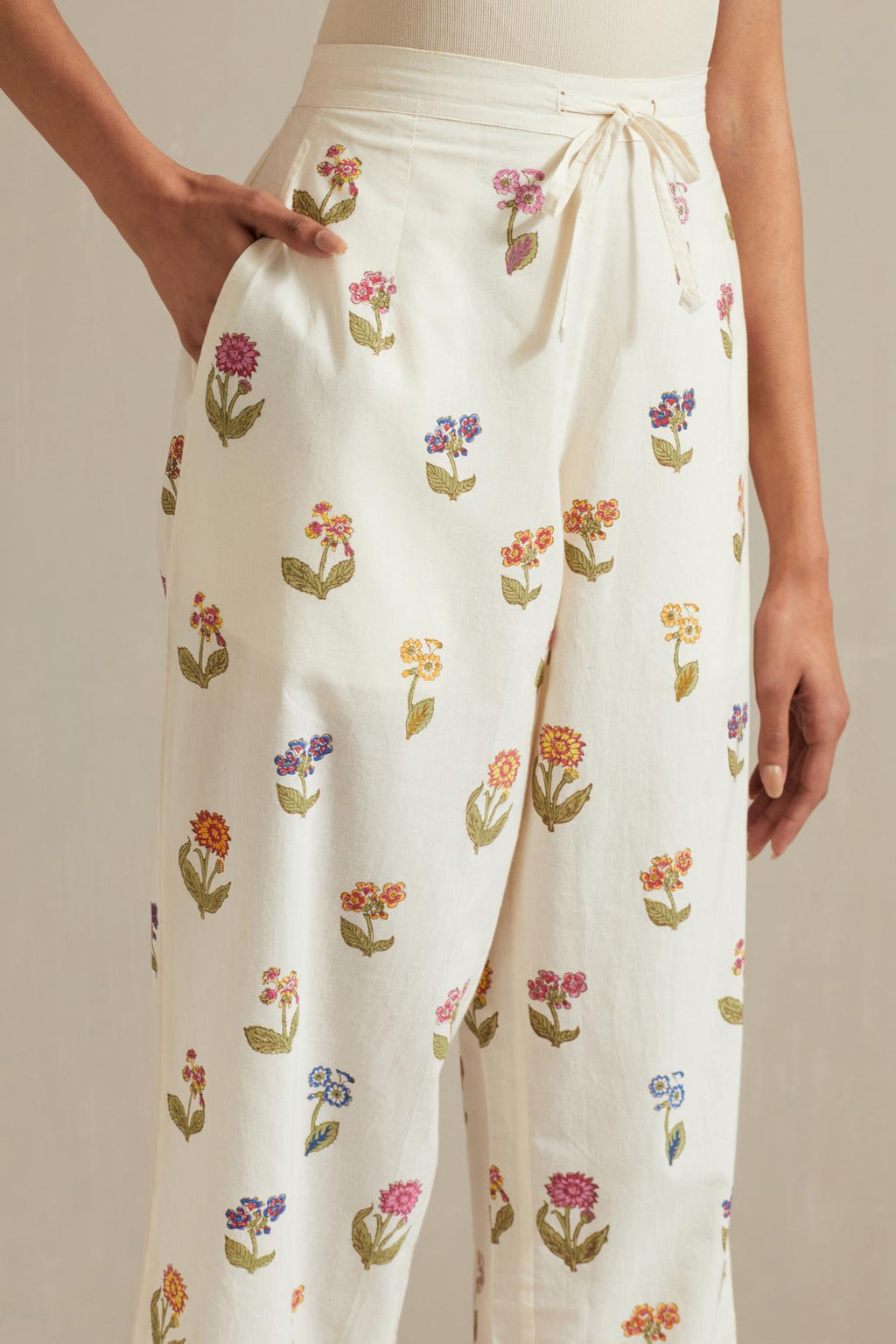 Off white hand block printed Cotton straight pants with all-over multi colored flower.