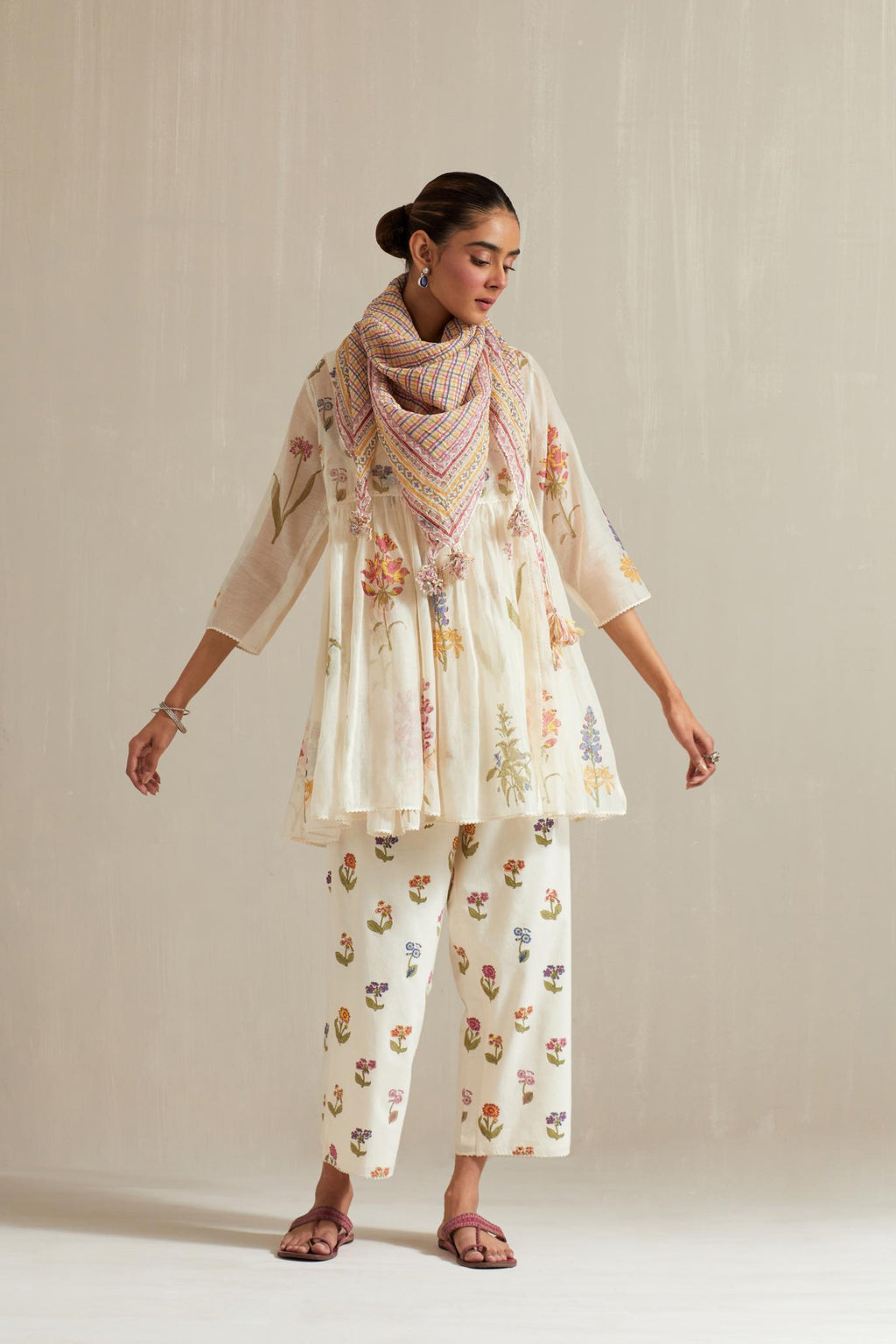 Off white hand block printed short angrakha kurta set with all-over multi colored flower.