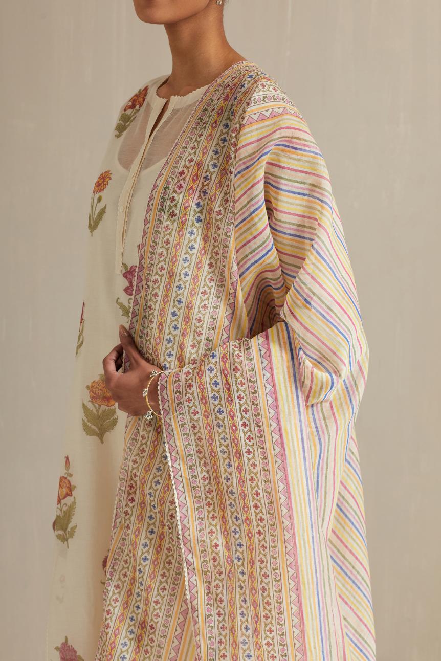 Off white cotton chanderi hand block printed straight kurta set with all-over multi colored flowers and side panels.