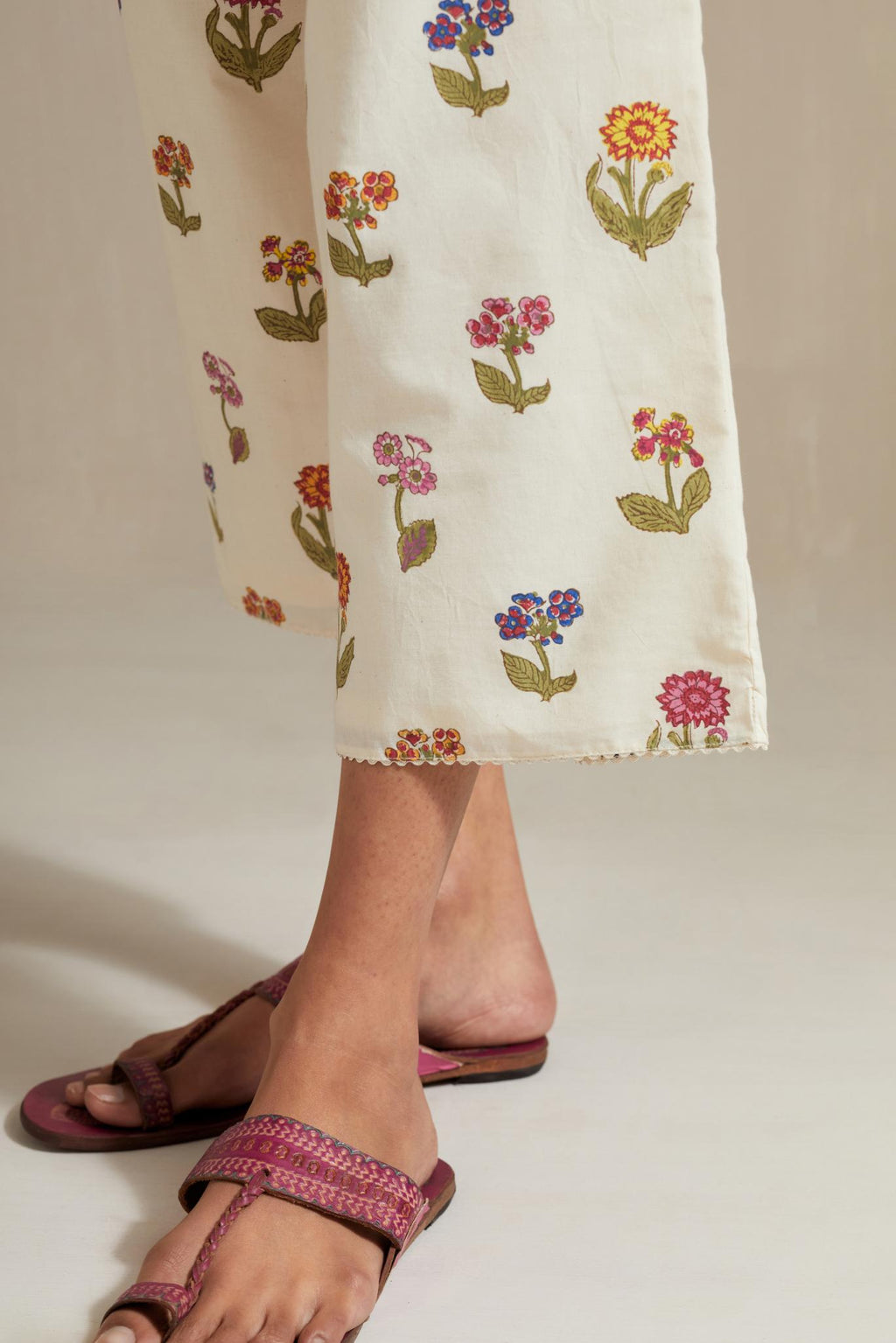 Off white hand block printed Cotton straight ankle length pants with all-over multi colored flower.