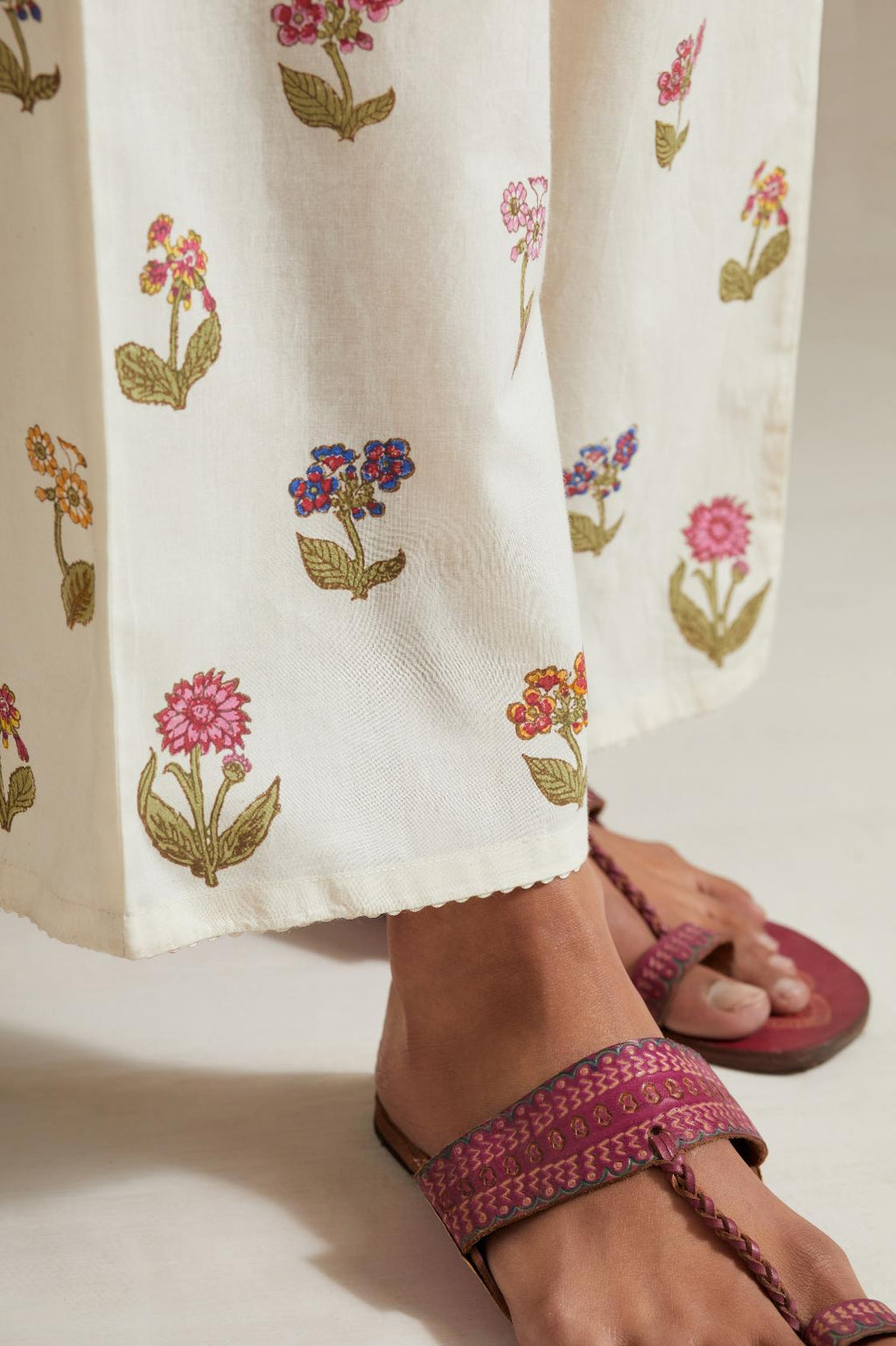 Off white hand block printed Cotton straight pants with all-over multi colored flower.