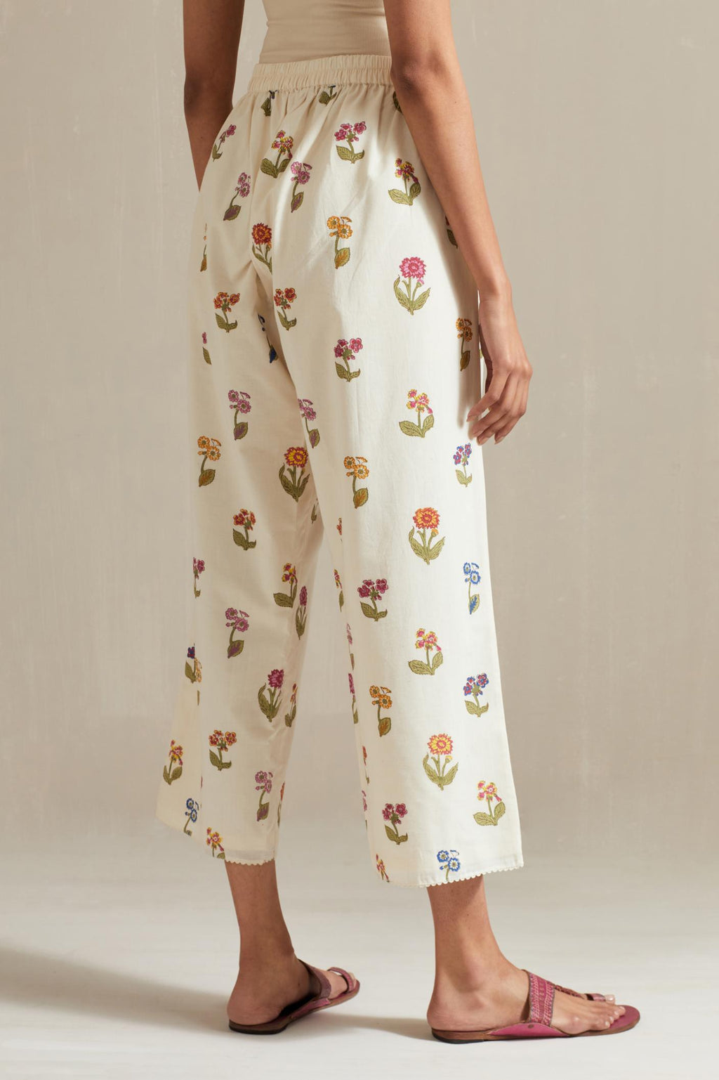 Off white hand block printed Cotton straight ankle length pants with all-over multi colored flower.