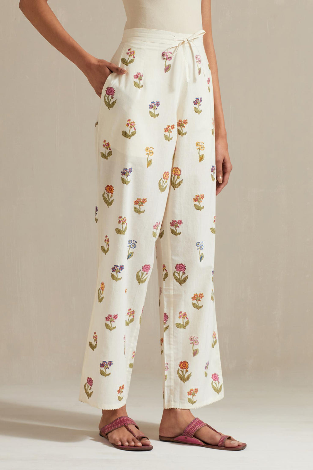 Off white hand block printed Cotton straight pants with all-over multi colored flower.