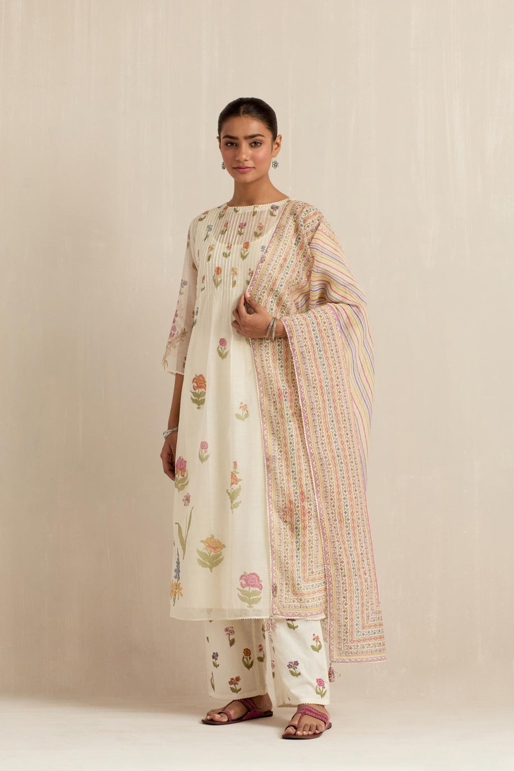 Off white cotton chanderi hand block printed kurta set with pin tucks at yoke and all-over multi colored flower.