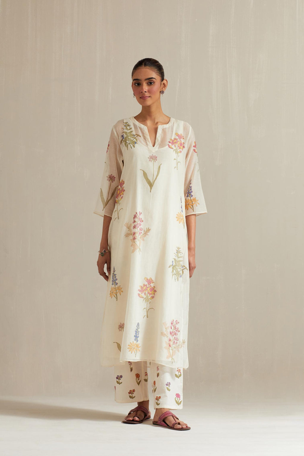Off white cotton chanderi hand block printed kurta set with all-over multi colored flower.