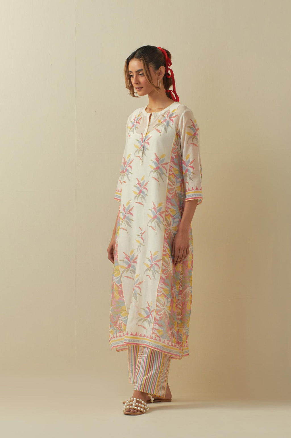 Off white cotton chanderi hand block printed straight kurta set with all-over multi colored flowers and side panels.