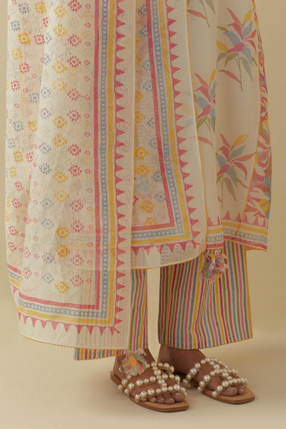 Off white cotton chanderi hand block printed straight kurta set with all-over multi colored flowers and side panels.