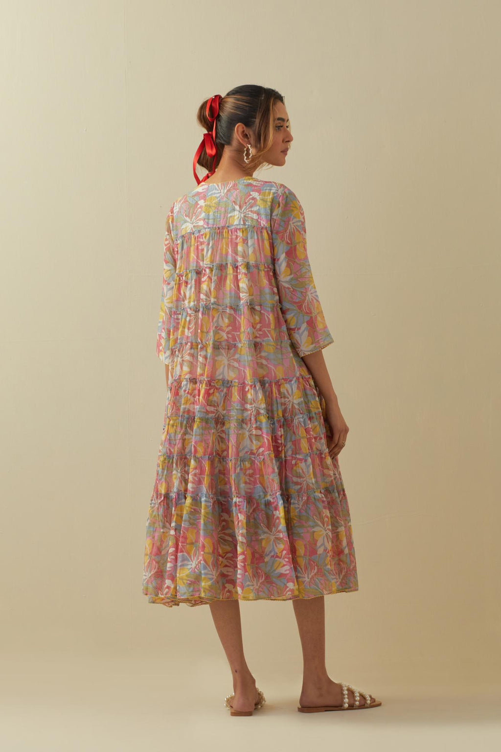Off white cotton chanderi multi-tiered dress with quilted yoke and all-over multi colored floral hand block print.
