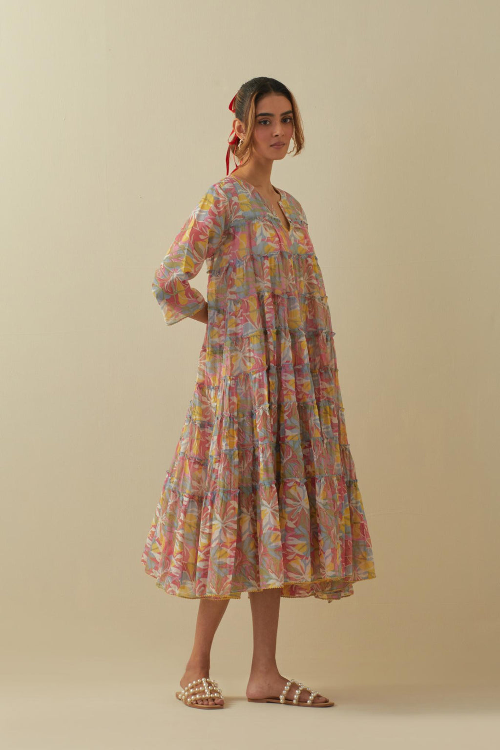 Off white cotton chanderi multi-tiered dress with quilted yoke and all-over multi colored floral hand block print.
