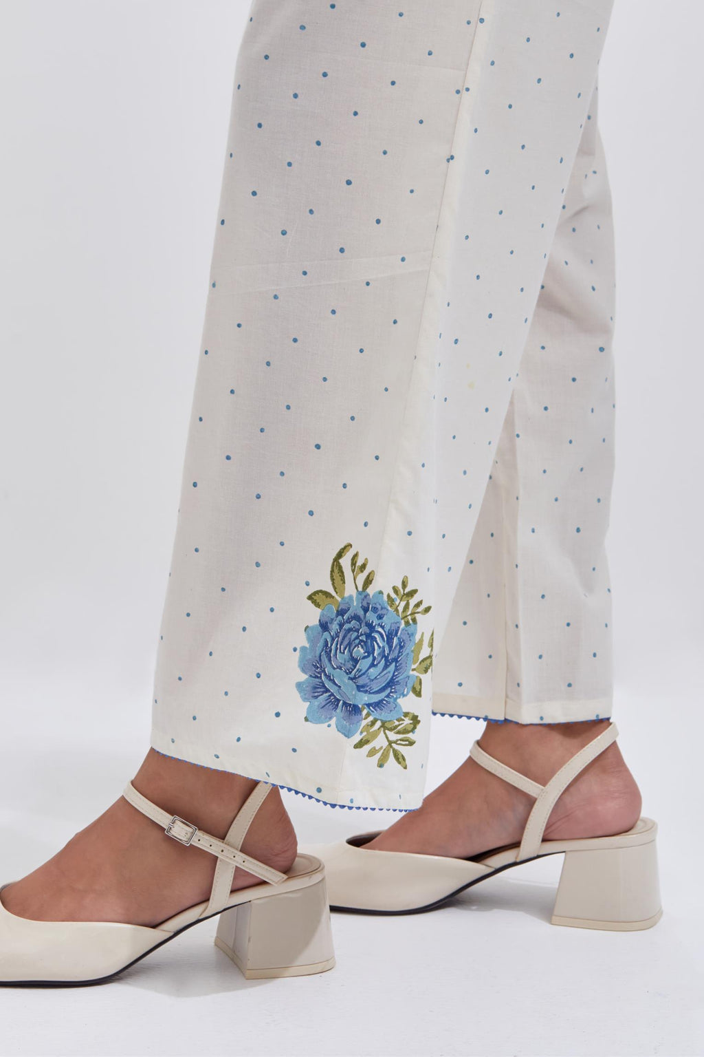 Off white cotton straight pants with all-over blue & green hand block print.