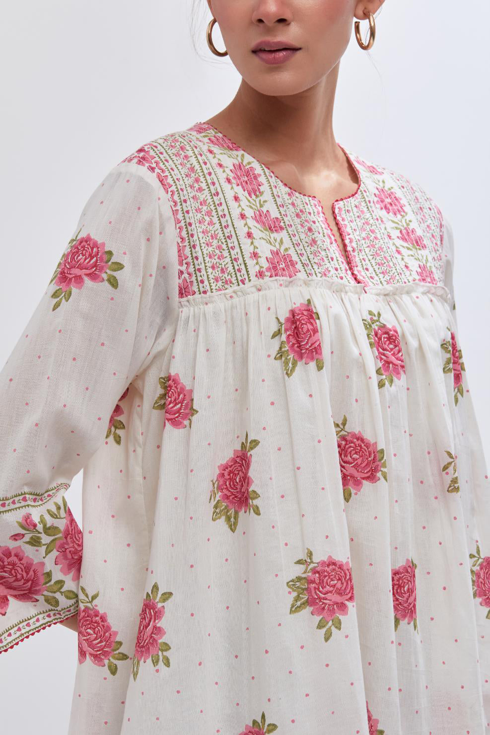 Off white cotton short top with quilted yoke and all-over pink & green floral hand block print.