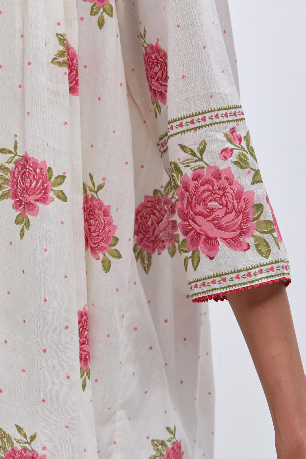Off white cotton short top with quilted yoke and all-over pink & green floral hand block print.