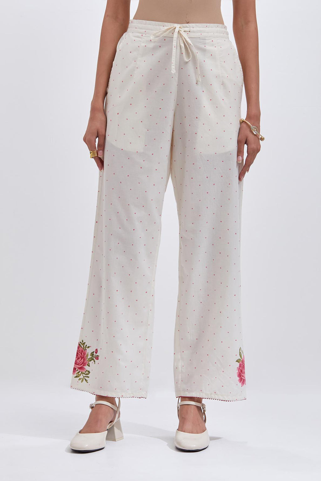 Off white cotton straight pants with all-over pink & green hand block print.