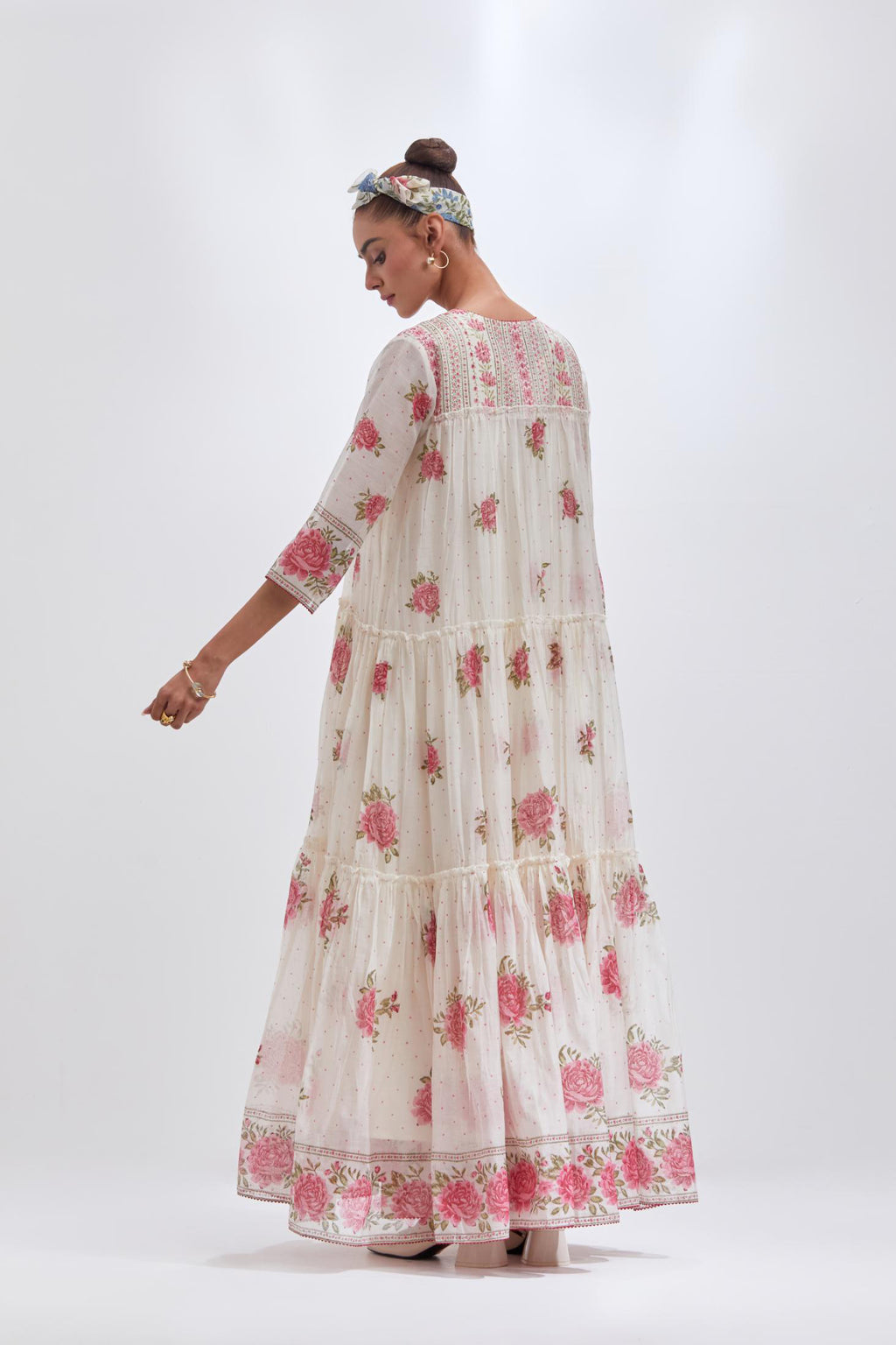 Off white three-tiered kurta set with quilted yoke and all-over pink & green floral hand block print.