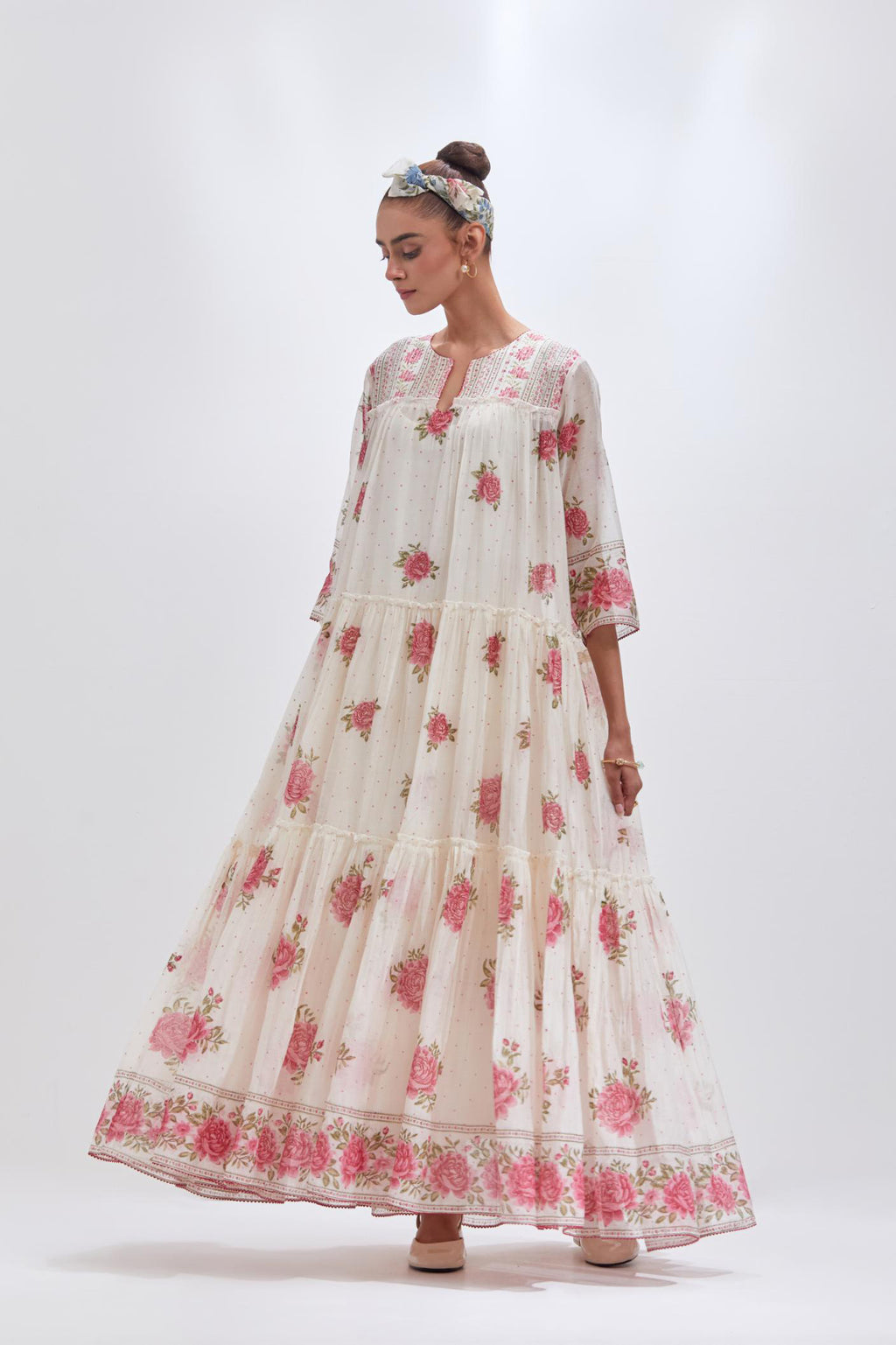 Off white three-tiered kurta set with quilted yoke and all-over pink & green floral hand block print.