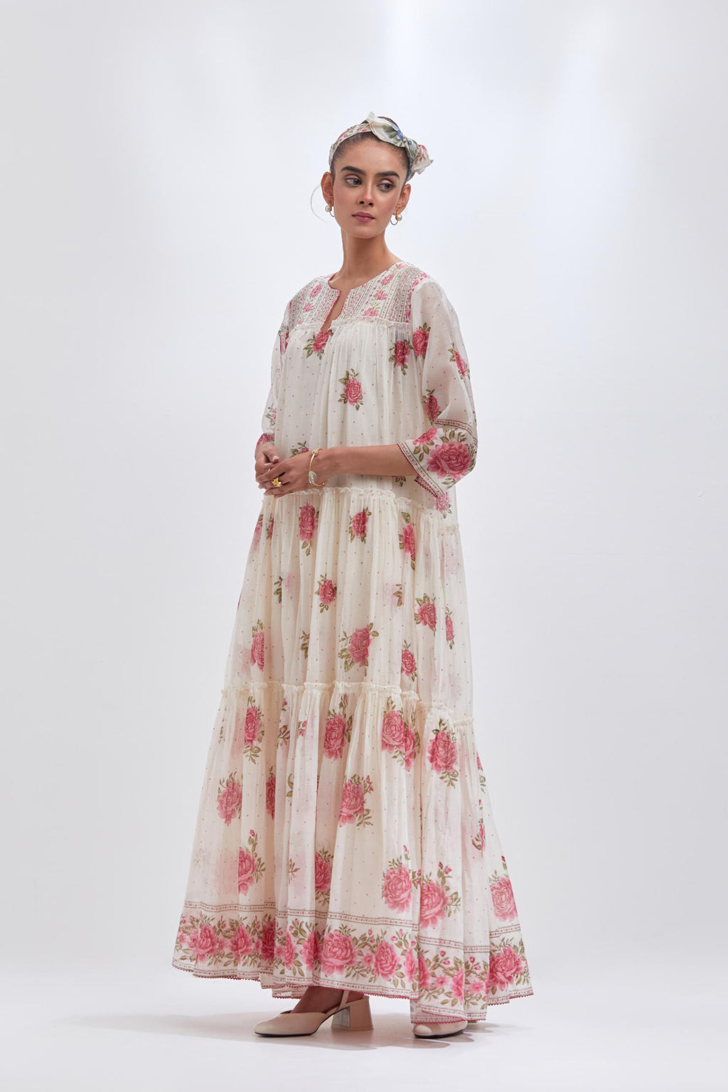 Off white three-tiered kurta set with quilted yoke and all-over pink & green floral hand block print.