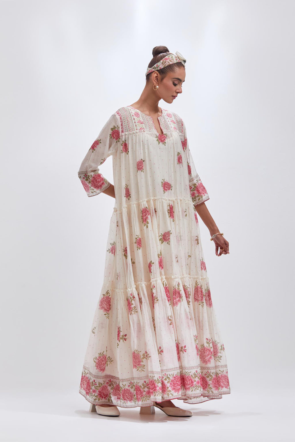 Off white three-tiered kurta set with quilted yoke and all-over pink & green floral hand block print.