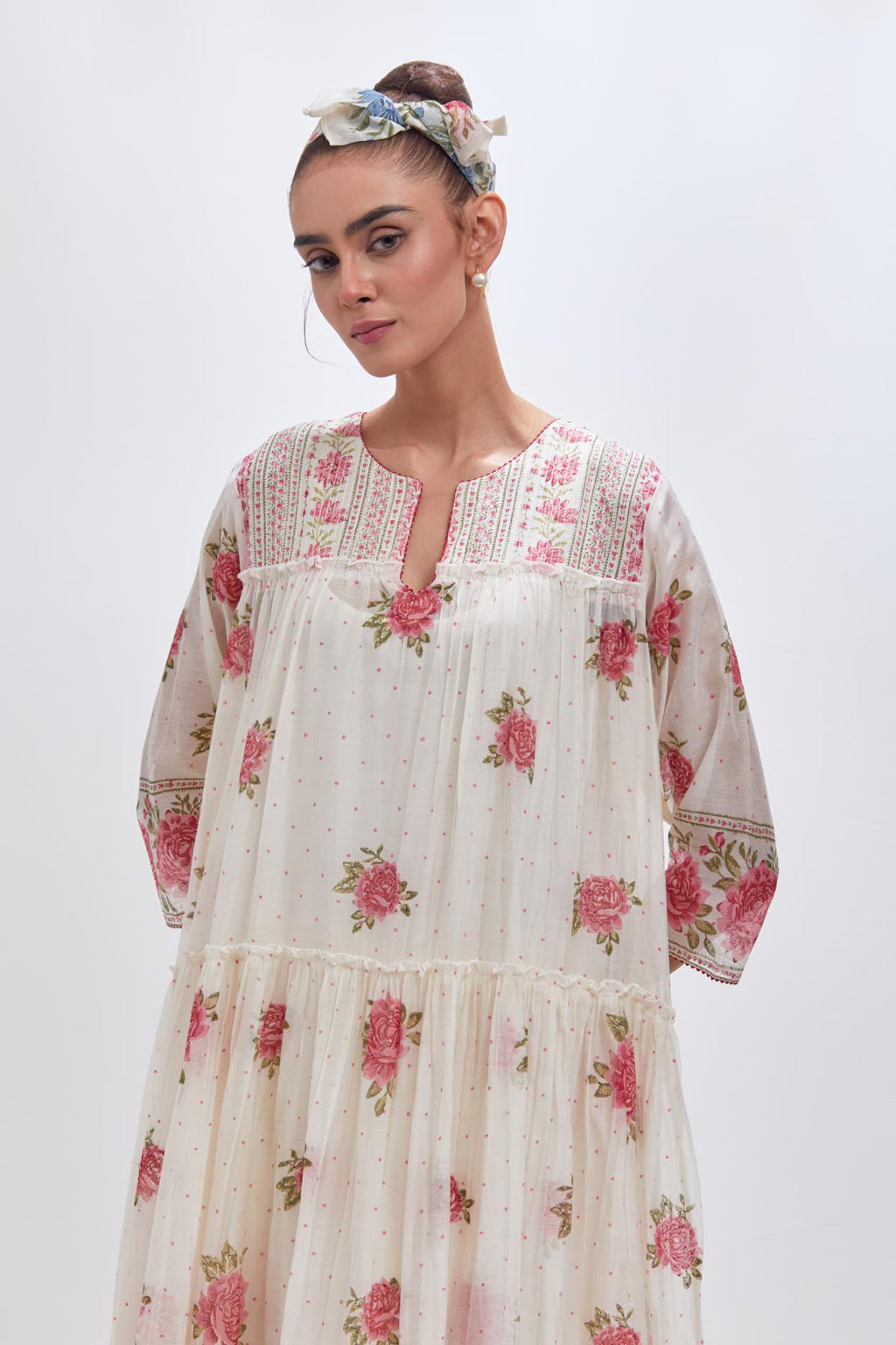 Off white three-tiered kurta set with quilted yoke and all-over pink & green floral hand block print.