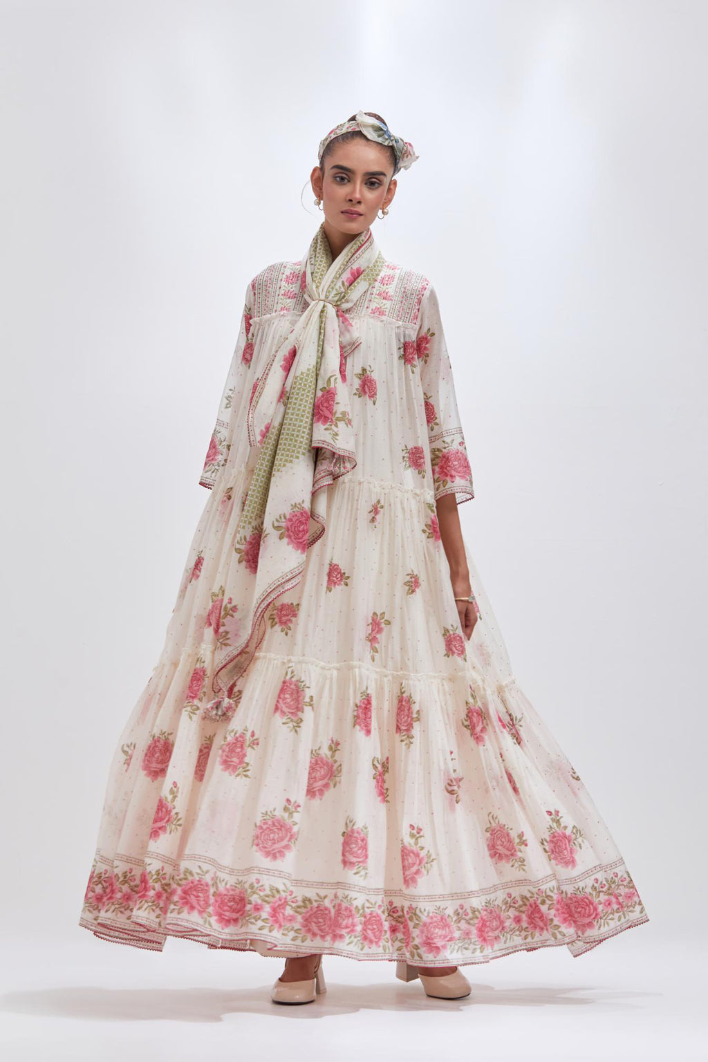 Off white three-tiered kurta set with quilted yoke and all-over pink & green floral hand block print.