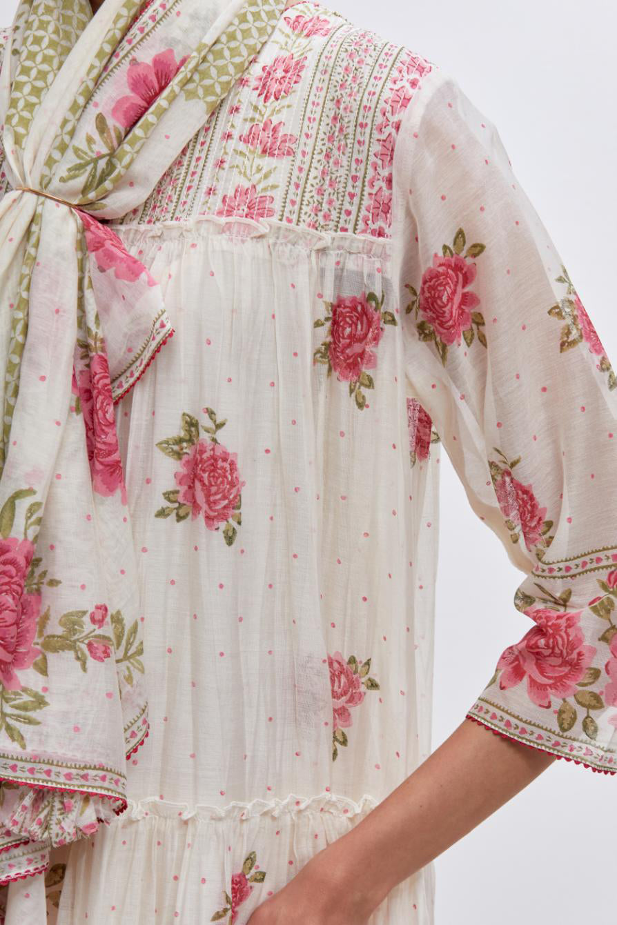 Off white three-tiered kurta set with quilted yoke and all-over pink & green floral hand block print.