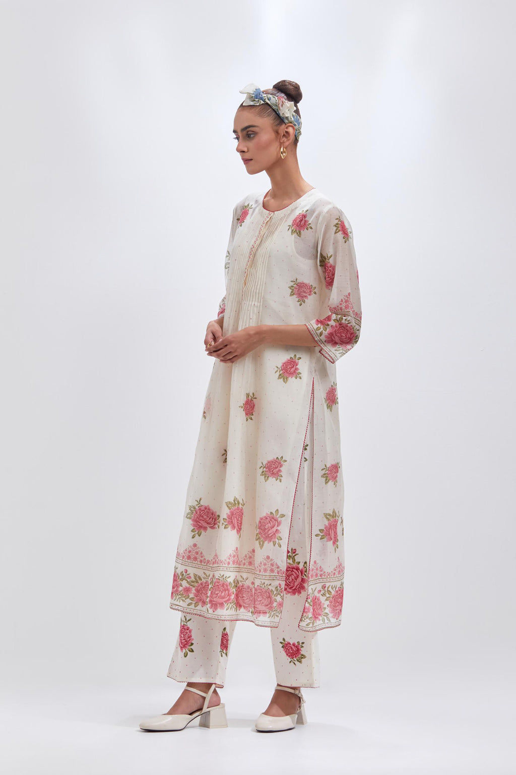 Off white cotton chanderi straight kurta set with all-over pink & green hand block print, highlighted with pin tucks at yoke.