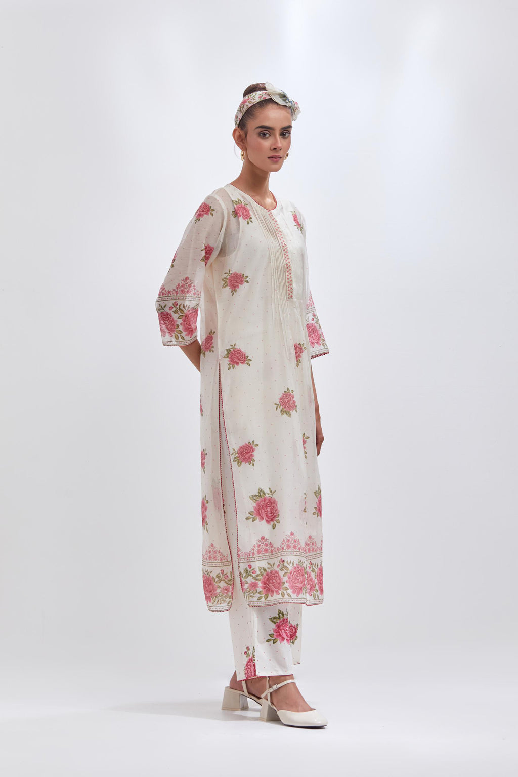 Off white cotton chanderi straight kurta set with all-over pink & green hand block print, highlighted with pin tucks at yoke.