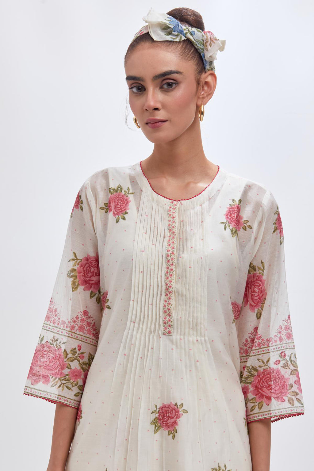 Off white cotton chanderi straight kurta set with all-over pink & green hand block print, highlighted with pin tucks at yoke.