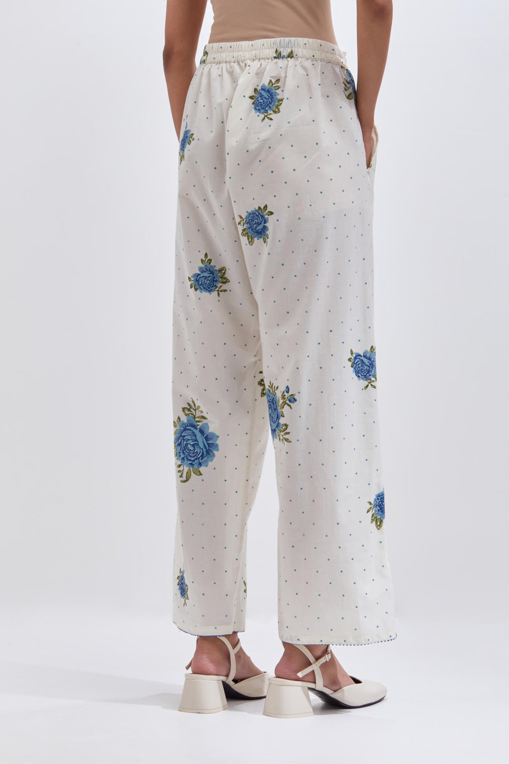 Off white cotton straight pants with all-over blue & green floral hand block print.