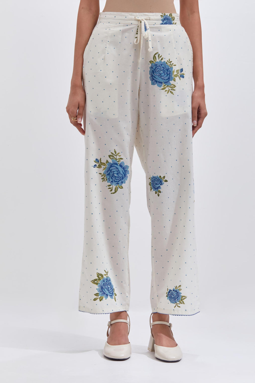 Off white cotton straight pants with all-over blue & green floral hand block print.